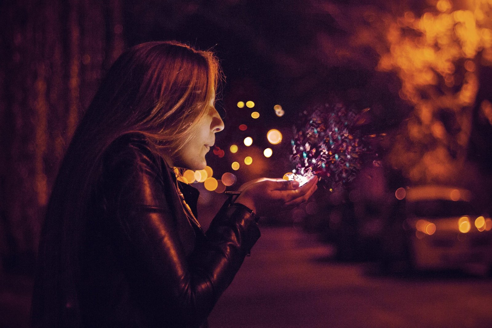 woman blowing sprinkle in her hand